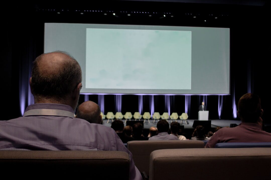 Technology conference with speaker presenting on large screen